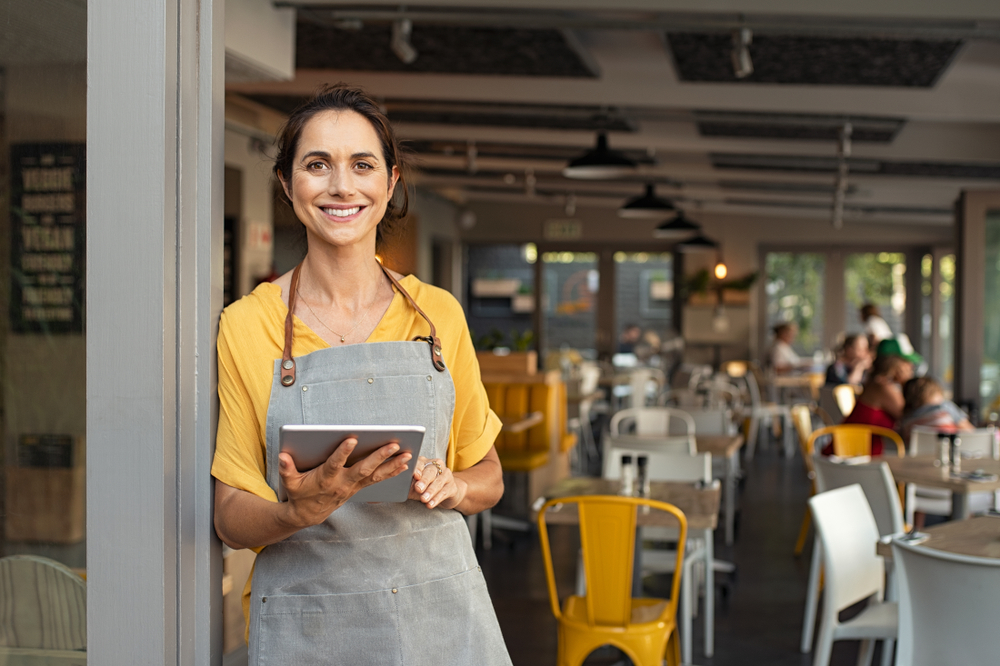 A small business owner greets customers at her business.